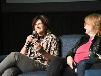 Amy Ray seated next to Emily Saliers on stage at Davidson College following screening of documentary