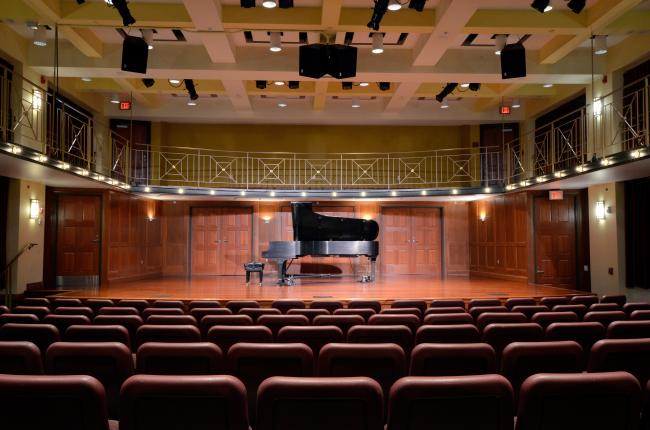 Tyler-Tallman auditorium with piano on stage and open seating