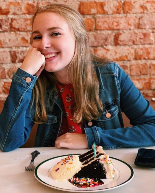 young woman having a slice of cake
