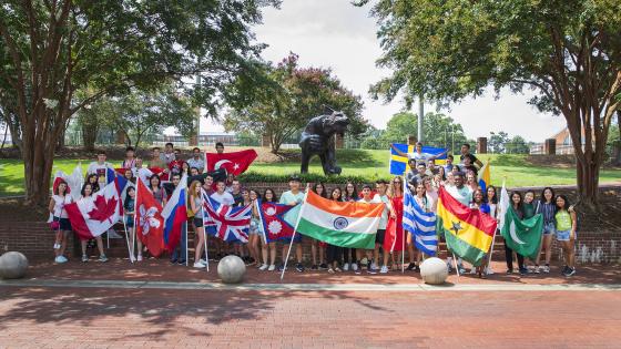 International Students with Flags from Various Countries by Bronze Wildcat