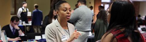 Law school recruiter talks to student at her booth