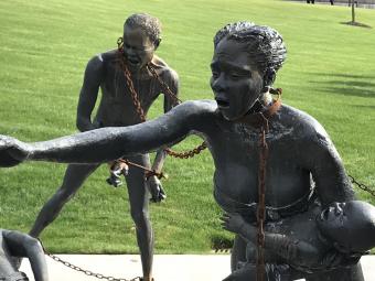 Monument of chained persons trying to free themselves