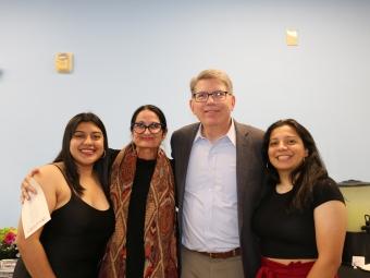 a group of two Latinx students, a professor and an older white man
