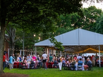 a tent surrounded by string lights at dusk
