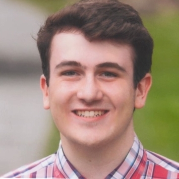 a young white man with curly brown hair