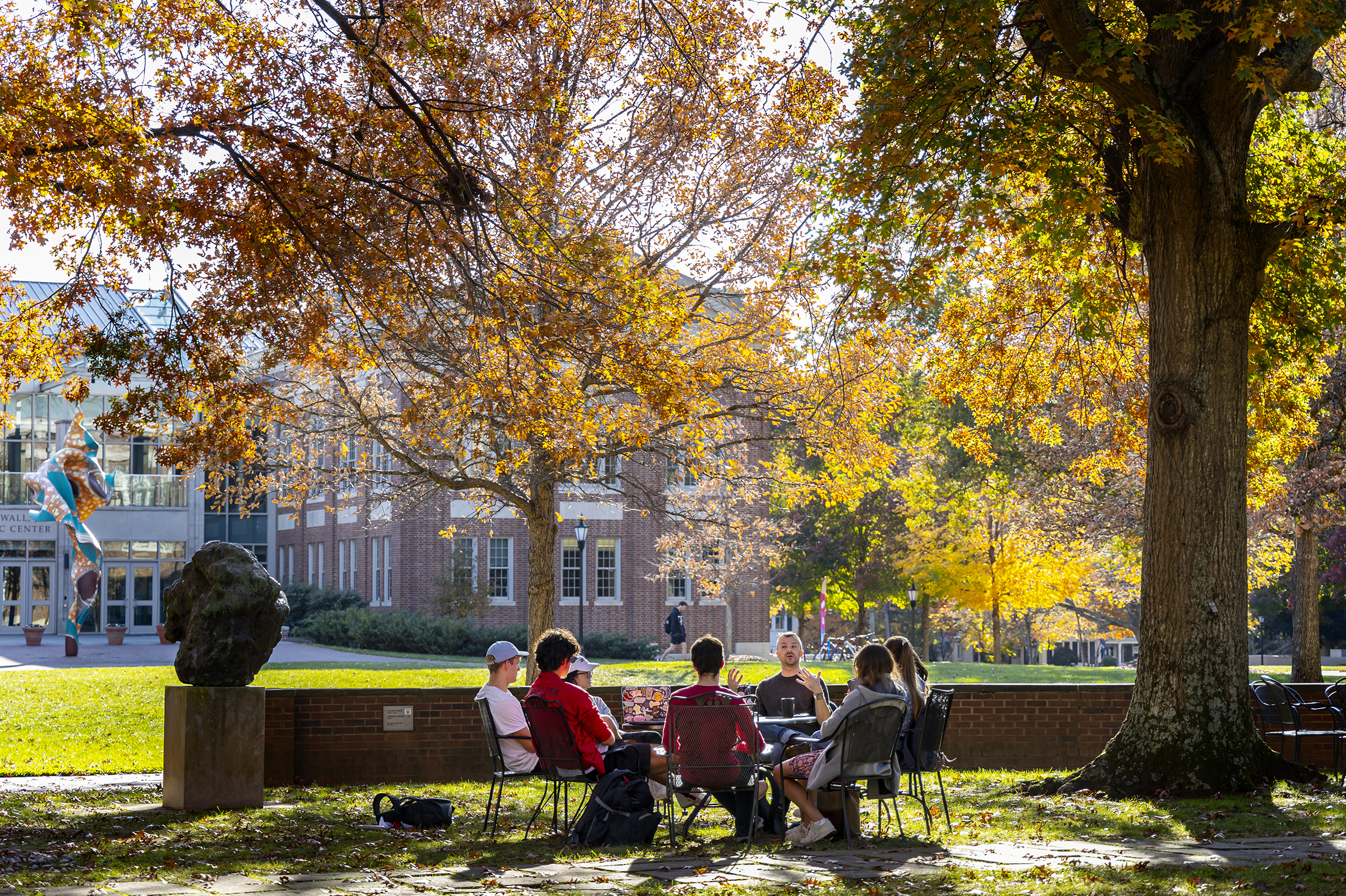 Prof. Patricio Boyer and Students gather outside on a beautiful fall day