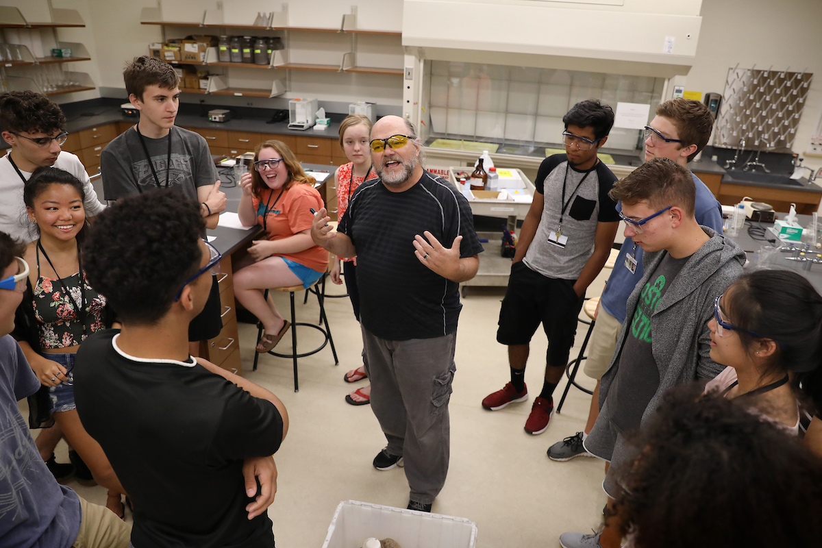 Durwin Striplin in Classroom with Students Gathered Around Him