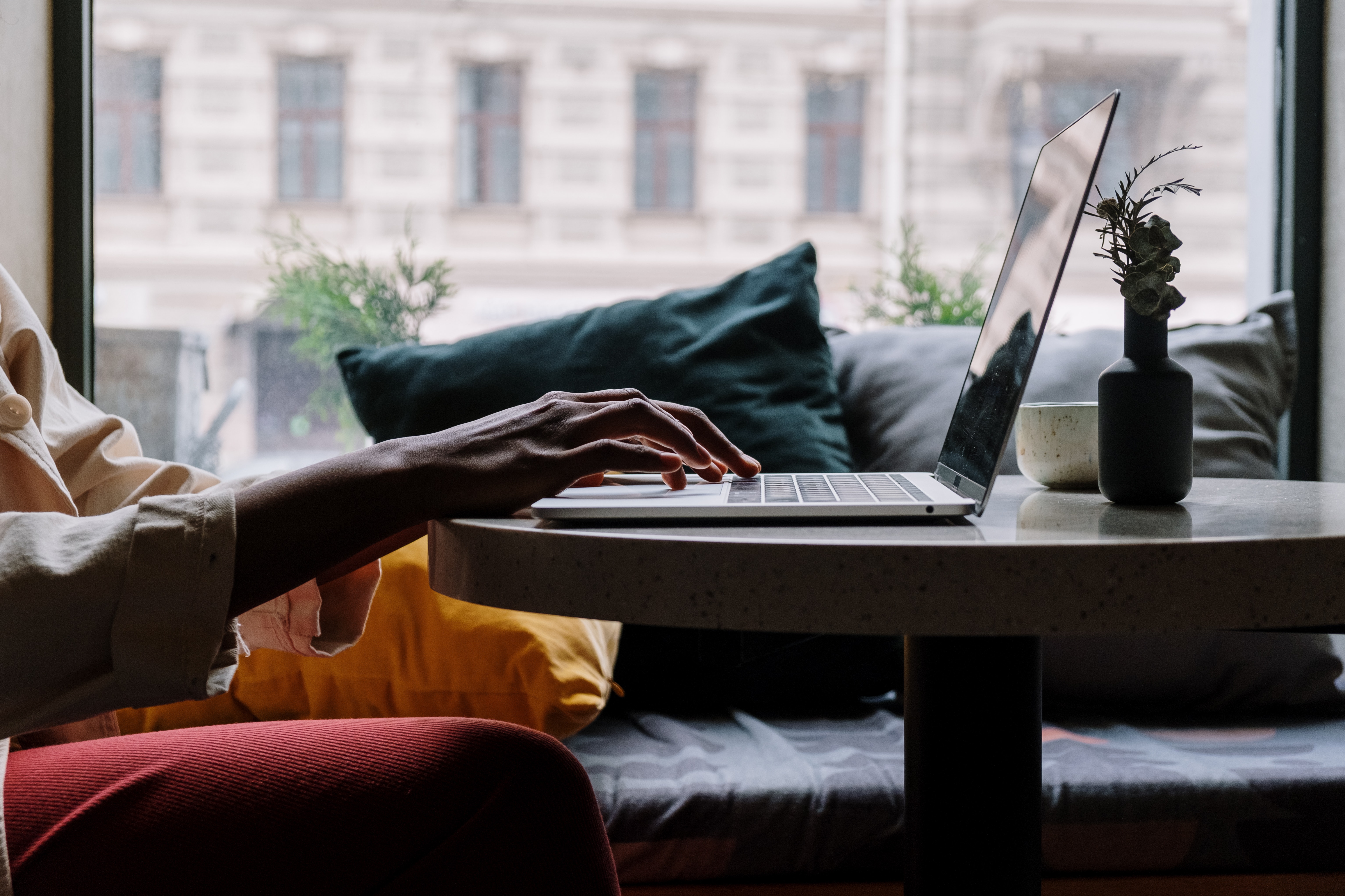 silhouette of hands on laptop