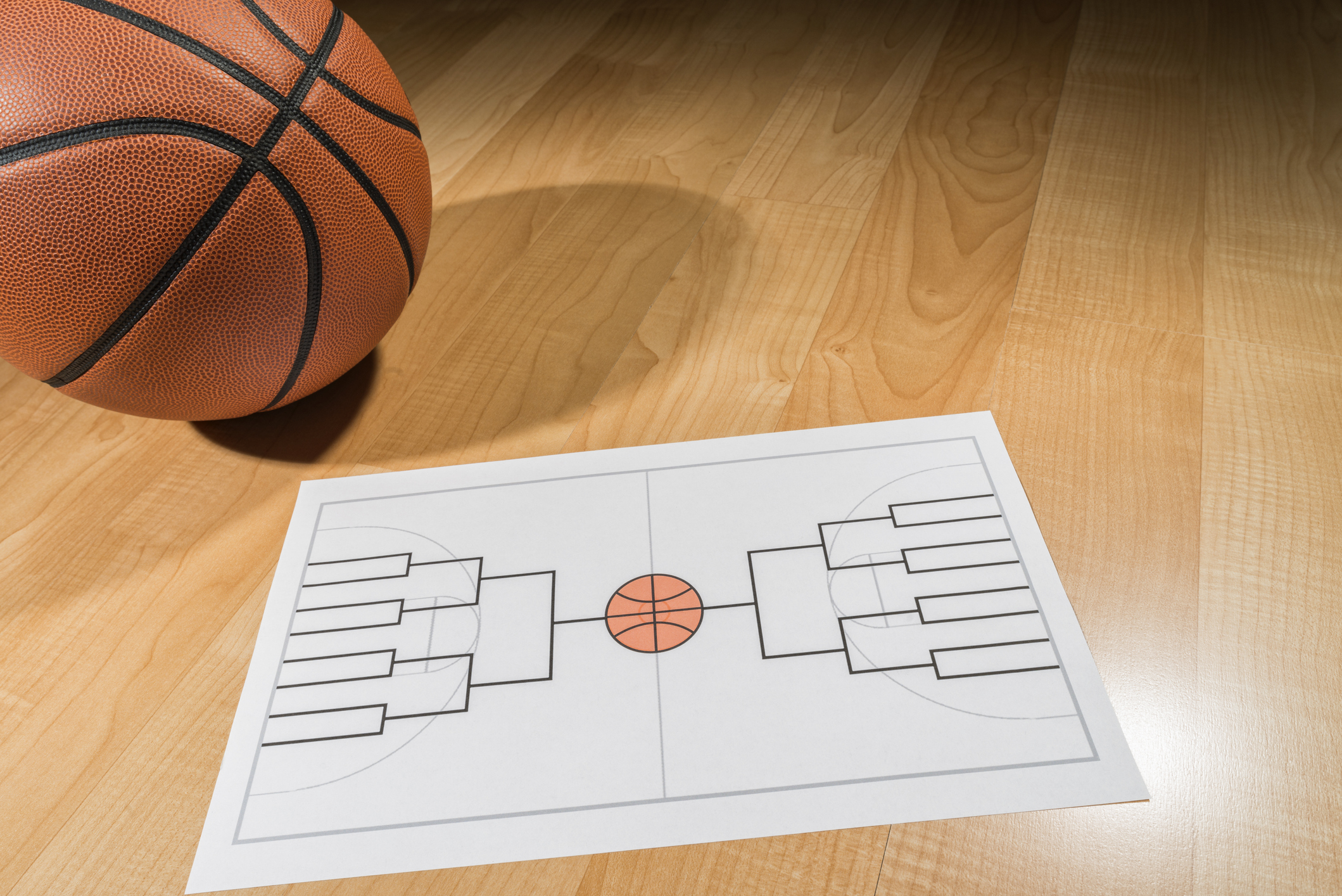 Image of basketball and brackets sheet for March Madness