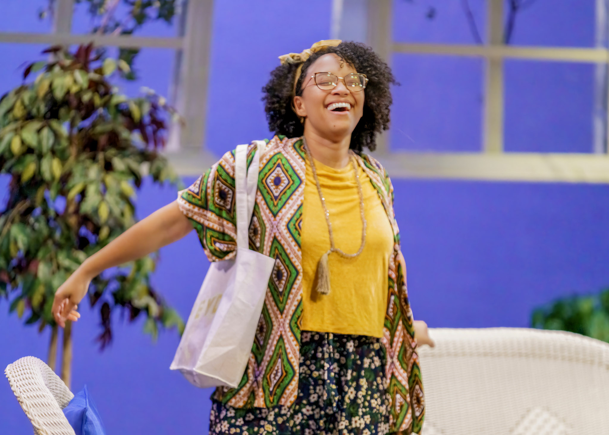 a young woman wearing bright clothes while in a theatre production