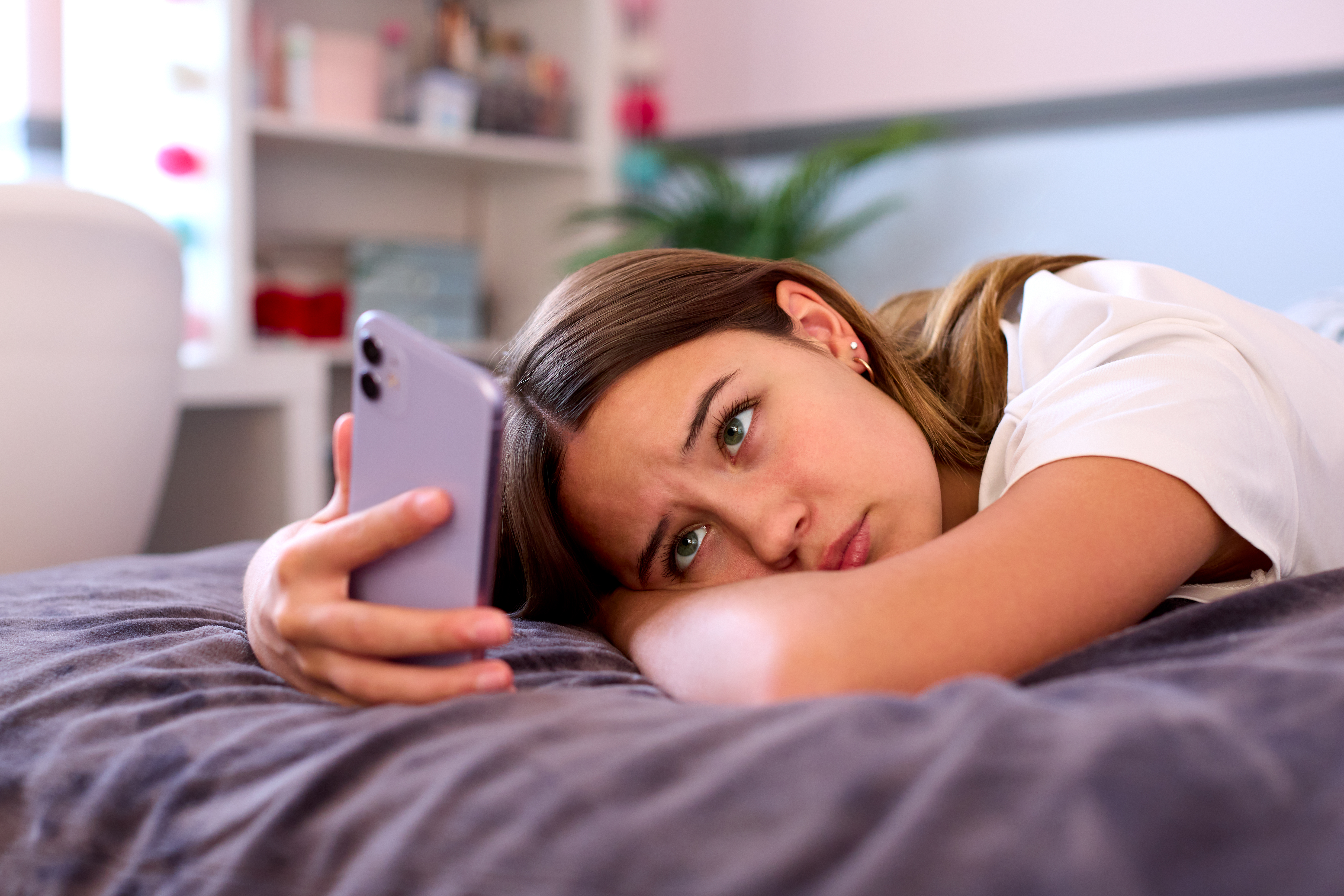 Teen sadly scrolling social media