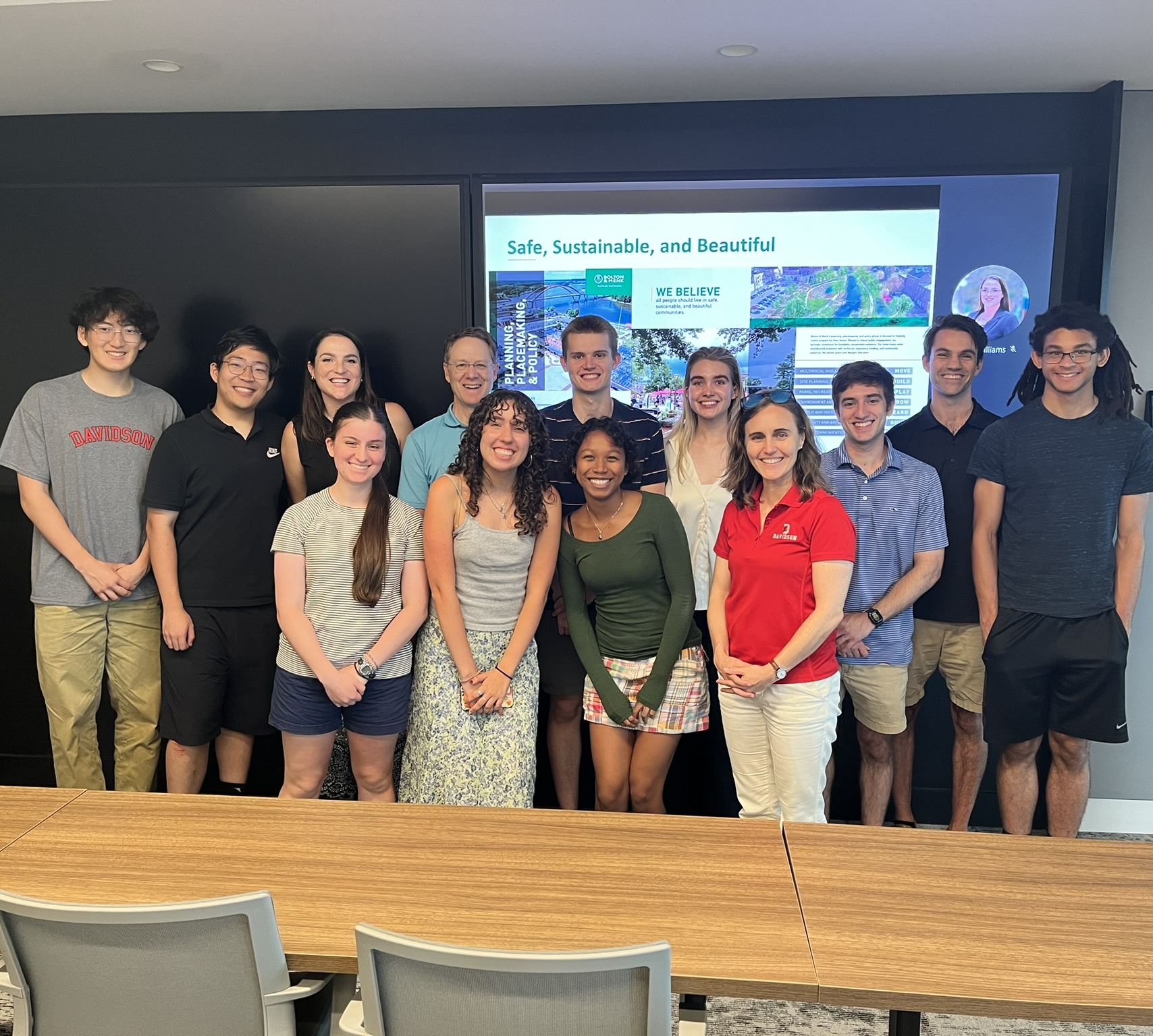 a group of students and adults together in a conference room