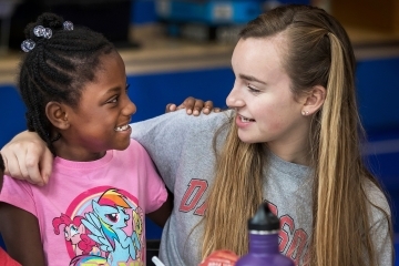 Davidson Student and Freedom School Student smile at each other