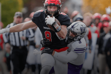 Davidson Football Player Clutching Ball While Running