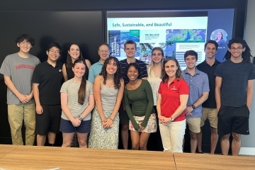 a group of students and adults together in a conference room