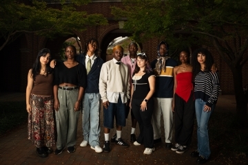 a group of students standing together on a college campus