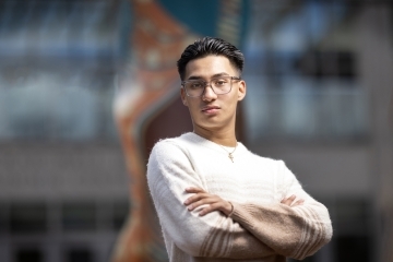 a young man with glasses and black hair