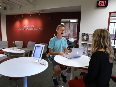 Student sits with career counselor to discuss job opportunities