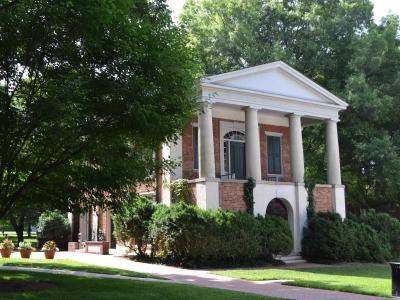 Phi Hall exterior through the trees