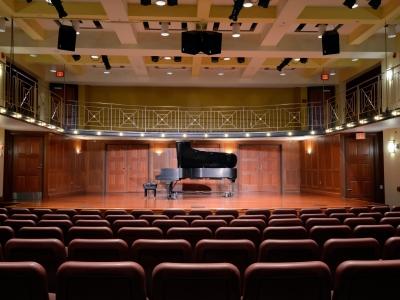 Tyler-Tallman auditorium with piano on stage and open seating