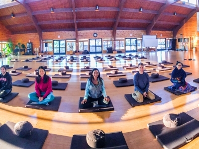 Students sit on meditation cushions