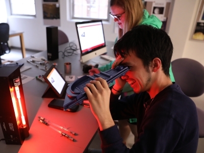 Student looks through physics apparatus