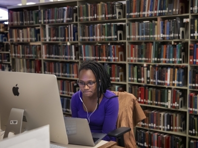 Student Working on Lab Computer and Laptop