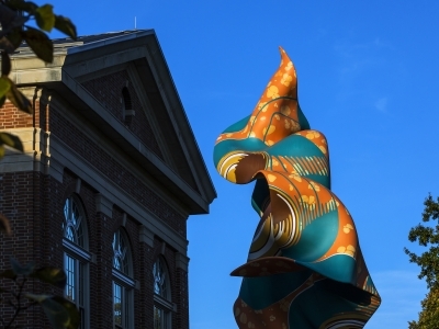 Shonibare Statue in front of Wall Building