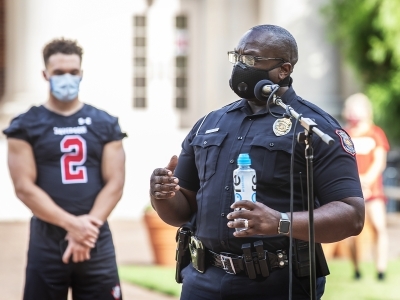 Social Justice Event - campus police officer speaking in front of Chambers