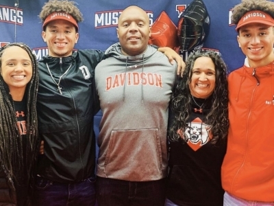 Admitted Students on football team with family