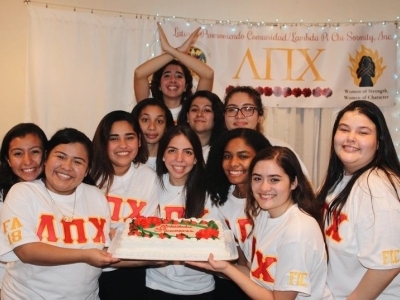 Latinx Sorority Women holding a cake