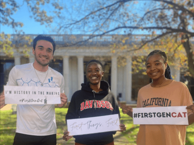 Students Holding First Gen Signs