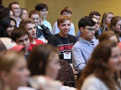 a group of students in audience smiling