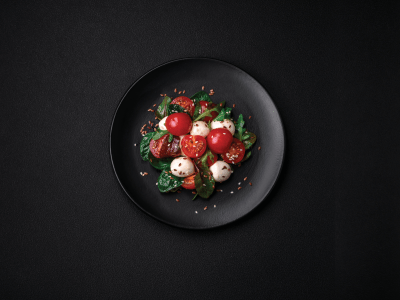 Caprese salad on black tablecloth