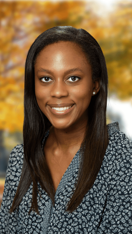 a young Black woman with black hair wearing a floral top