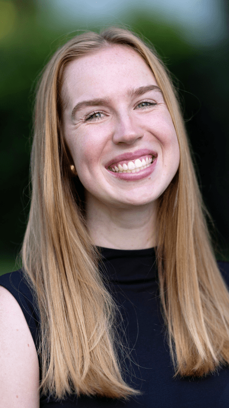 a young white woman with blonde hair wearing a black top