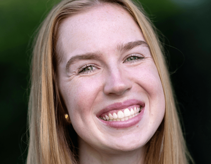 a young white woman with blonde hair wearing a black top