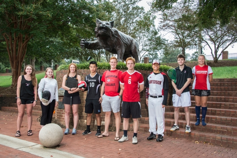 Members of each club sports team line up by the Wildcat statue in their respective uniforms