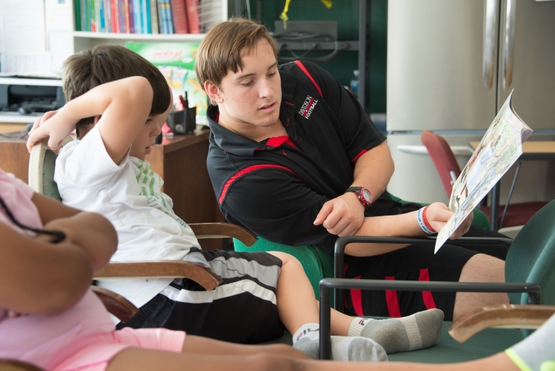 Sociology student reads book to small child