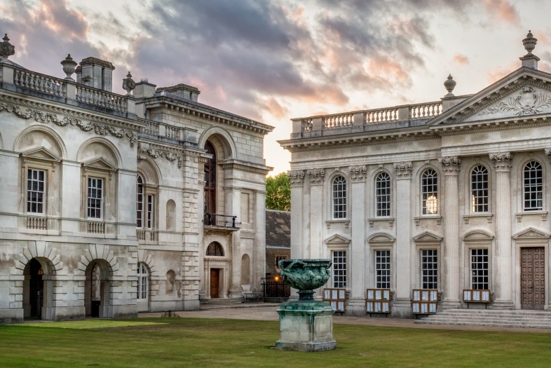 University of Cambridge marble buildings in front of a pink and blue cloudy sky