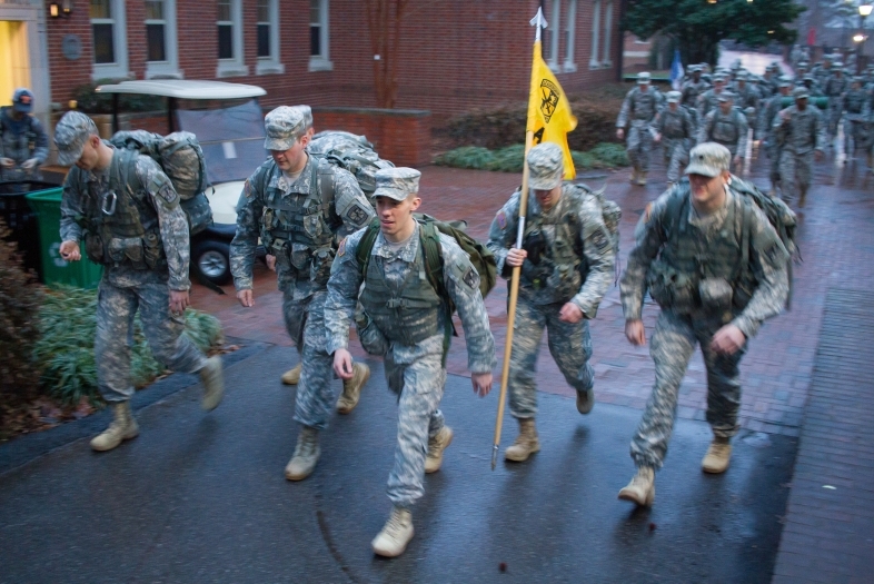 ROTC students in full uniform with gear walk the campus