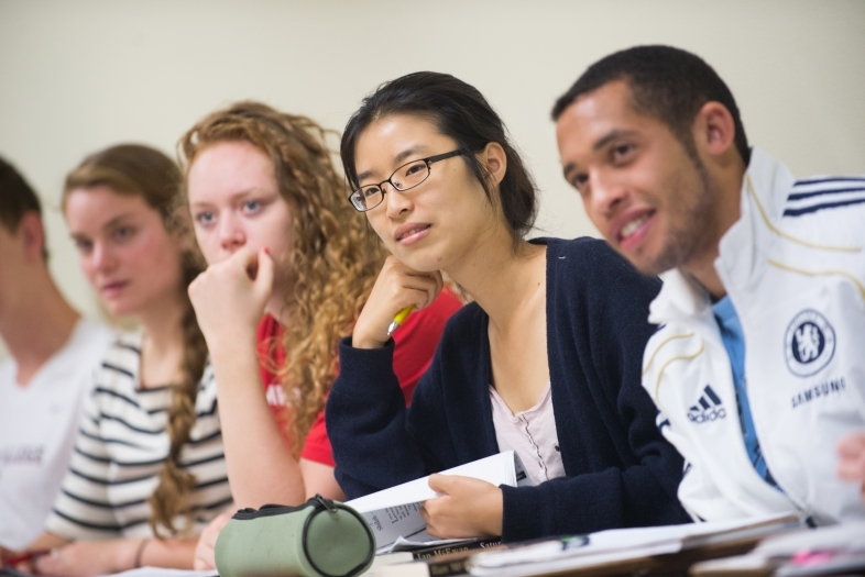 Photo of five students listening to a class lecture