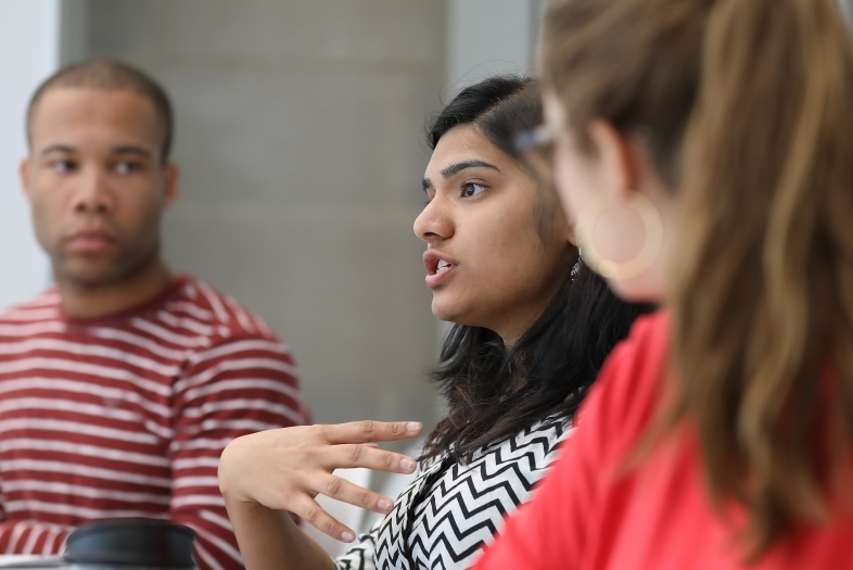 Student talks in class while peers look in her direction