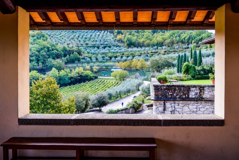 View of an Italian villa through an open window, showing the country side