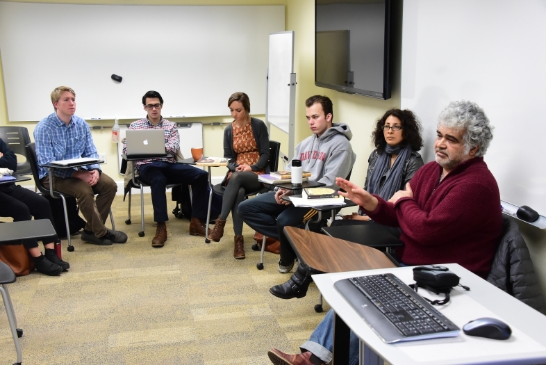 Arab studies class arranges desk in a circle while listening to a discussion led by Khaled Khalifa, a Syrian screenwriter and novelist