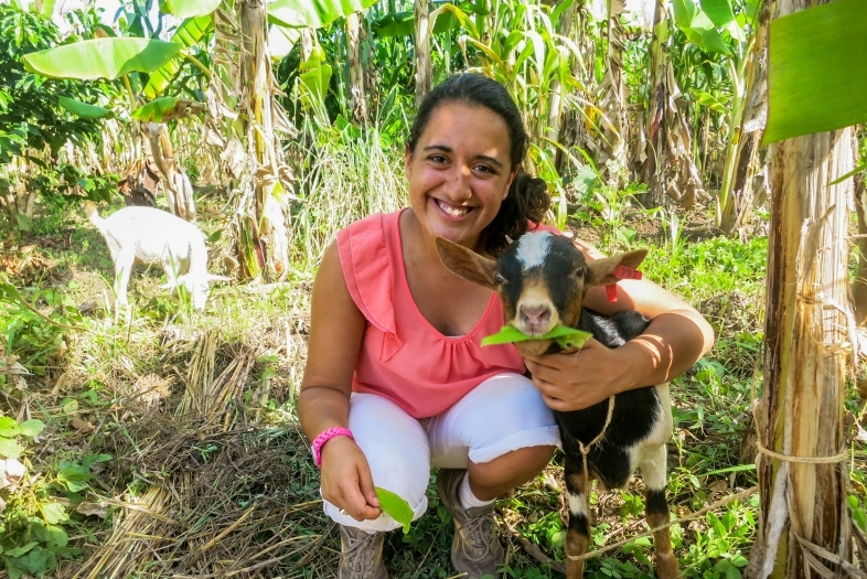 Student doing Nourish Internship interacts with a goat