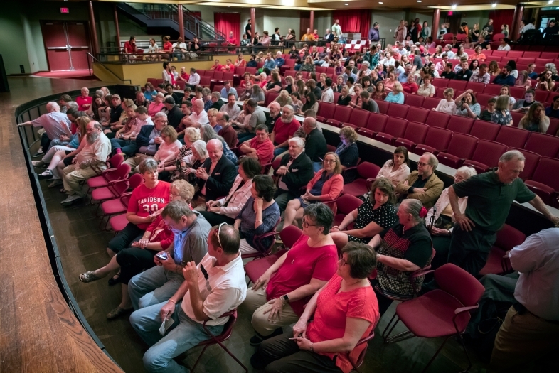 Birds eye view of duke performance hall with all staff sitting in the seats