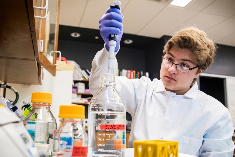 Student in lab with science equipment