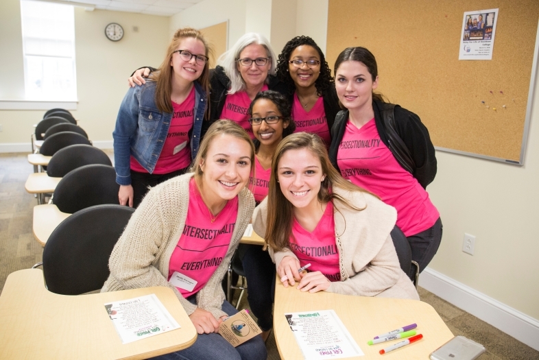 Women's Leadership Conference speakers gather in a classroom