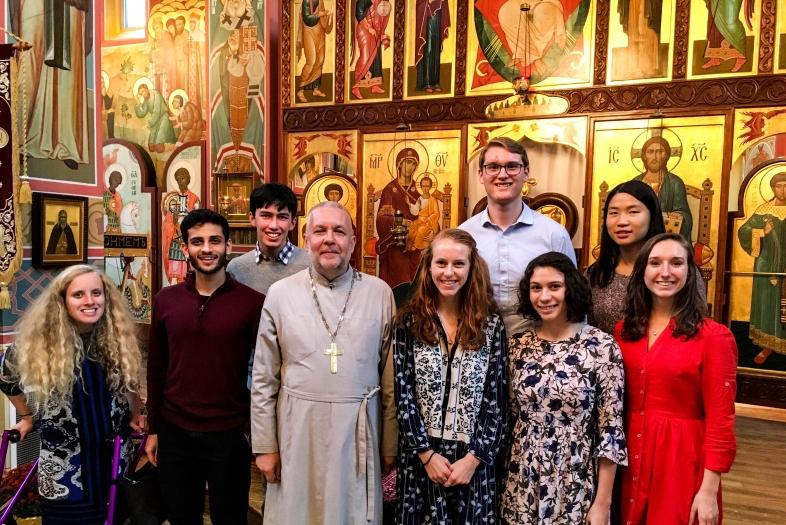 Interfaith club visits an orthodox christian church and poses with priest